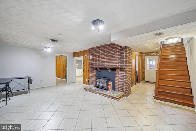 living room with light tile patterned floors, stairs, and visible vents