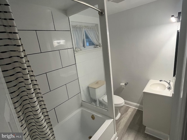 full bathroom with baseboards, toilet, wood finished floors, shower / bathtub combination with curtain, and vanity