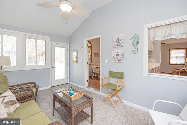 living room featuring lofted ceiling, baseboards, and a wealth of natural light