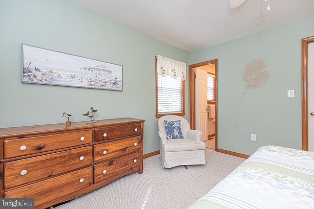 bedroom featuring a ceiling fan, light colored carpet, and baseboards