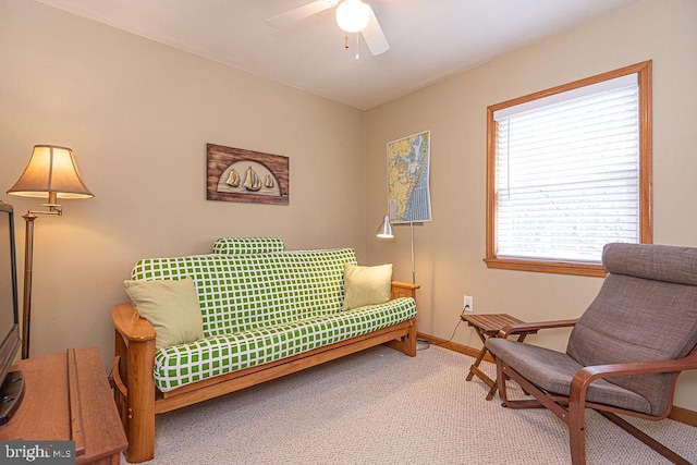 sitting room featuring carpet flooring, a ceiling fan, and baseboards