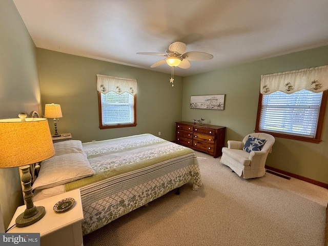 bedroom featuring baseboards, multiple windows, and carpet floors