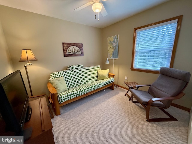 sitting room with carpet flooring, a ceiling fan, and baseboards