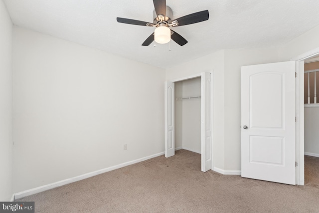 unfurnished bedroom featuring a ceiling fan, baseboards, a closet, and light carpet