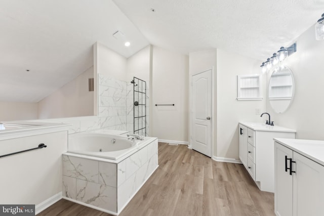 full bathroom with walk in shower, a whirlpool tub, two vanities, vaulted ceiling, and wood finished floors