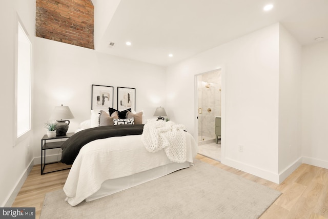 bedroom with light wood-type flooring, baseboards, and recessed lighting