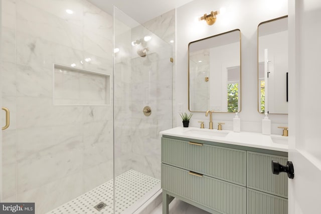 full bath featuring a sink, a shower stall, and double vanity