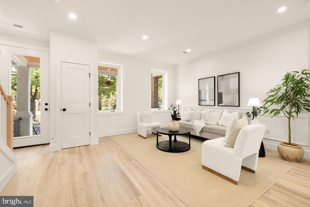 living room with recessed lighting, visible vents, baseboards, stairway, and light wood-type flooring