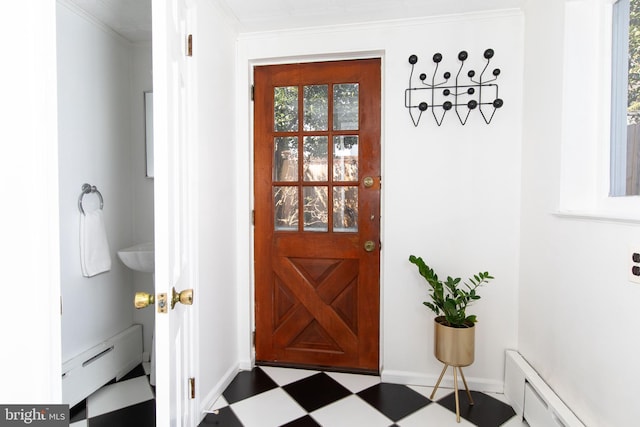 doorway with a baseboard heating unit, dark floors, ornamental molding, and baseboards