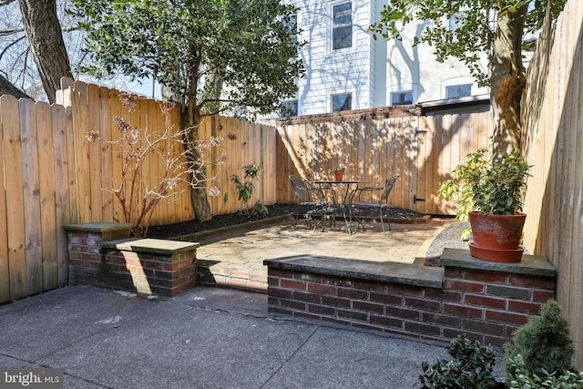 view of patio with a fenced backyard and outdoor dining space