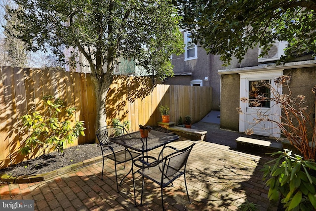 view of patio with a fenced backyard and outdoor dining space