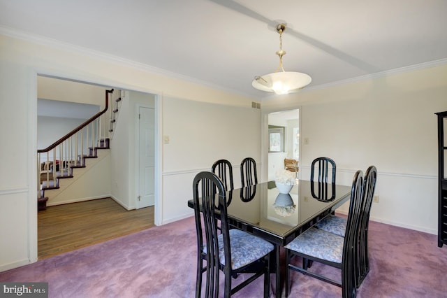 dining room featuring visible vents, crown molding, baseboards, stairs, and carpet flooring