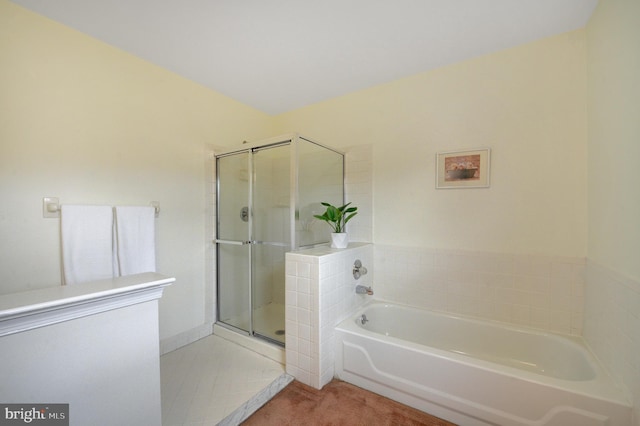 full bathroom with a stall shower and a garden tub