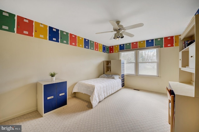 carpeted bedroom featuring baseboards and ceiling fan