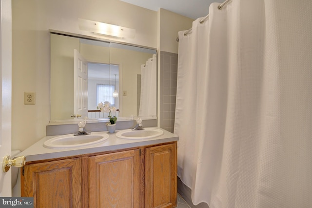 bathroom featuring double vanity and a sink