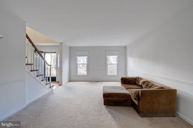 living area with stairway, carpet flooring, baseboards, and plenty of natural light