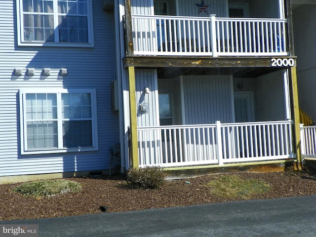 exterior space with a balcony and a porch