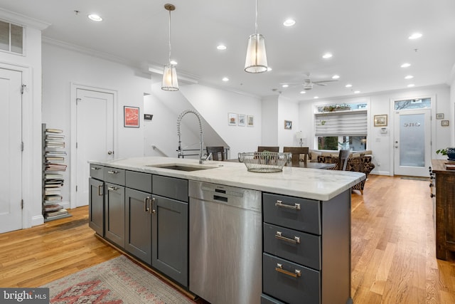 kitchen featuring stainless steel dishwasher, crown molding, decorative light fixtures, and a sink