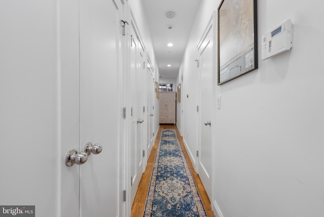 corridor with recessed lighting and light wood-type flooring