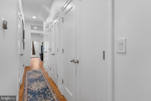 hall with recessed lighting and light wood-style floors