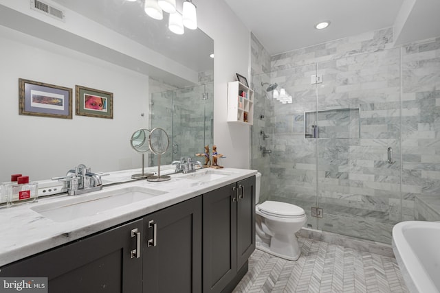 bathroom with double vanity, a stall shower, visible vents, and a sink