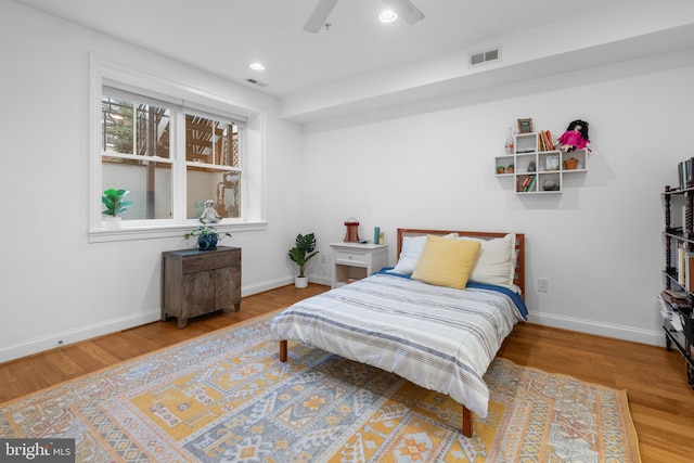 bedroom with visible vents, recessed lighting, baseboards, and wood finished floors