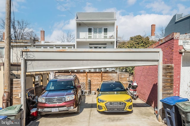 view of parking with fence