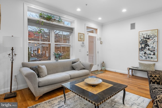 living room with recessed lighting, baseboards, and wood finished floors