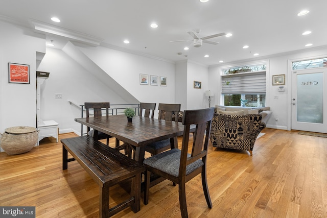 dining space with recessed lighting, light wood-type flooring, baseboards, and crown molding