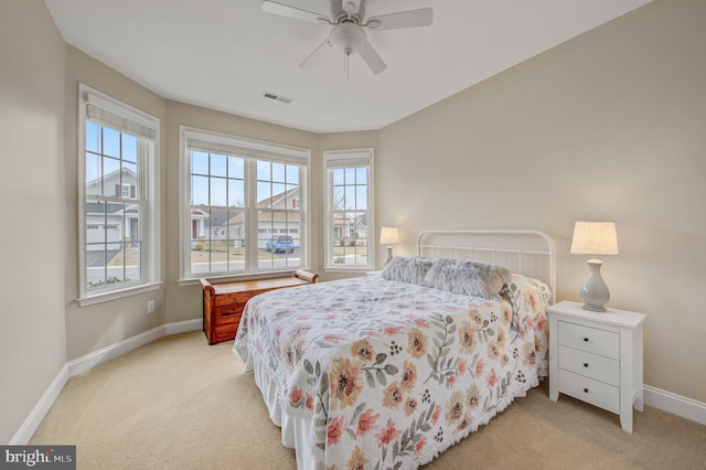 bedroom featuring baseboards, light carpet, visible vents, and ceiling fan