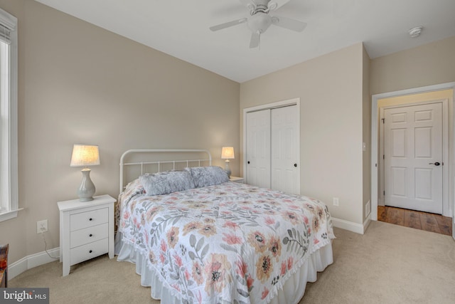 bedroom featuring baseboards, a closet, carpet floors, and ceiling fan