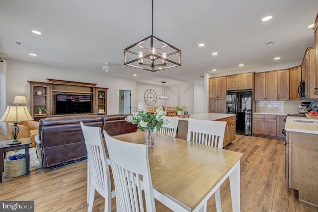 dining room with recessed lighting, visible vents, ceiling fan with notable chandelier, and light wood finished floors