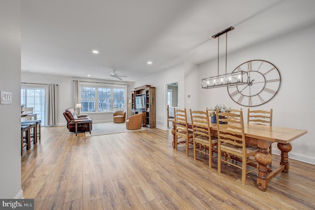 dining space with recessed lighting, ceiling fan with notable chandelier, baseboards, and wood finished floors