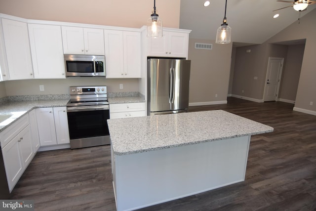 kitchen with stainless steel appliances, dark wood-style flooring, visible vents, white cabinets, and hanging light fixtures