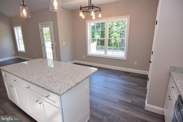 kitchen with baseboards, dark wood finished floors, and a center island