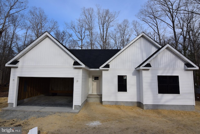 modern inspired farmhouse featuring a garage, roof with shingles, and board and batten siding