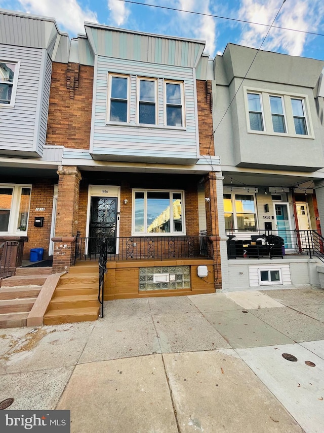 view of front of property featuring a porch and brick siding