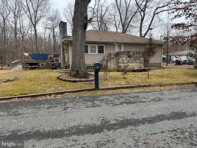 view of front of house with a chimney and a front lawn