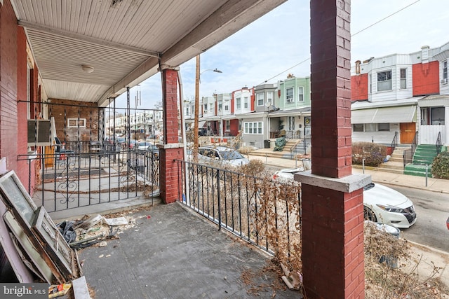 view of patio / terrace with a balcony and a residential view