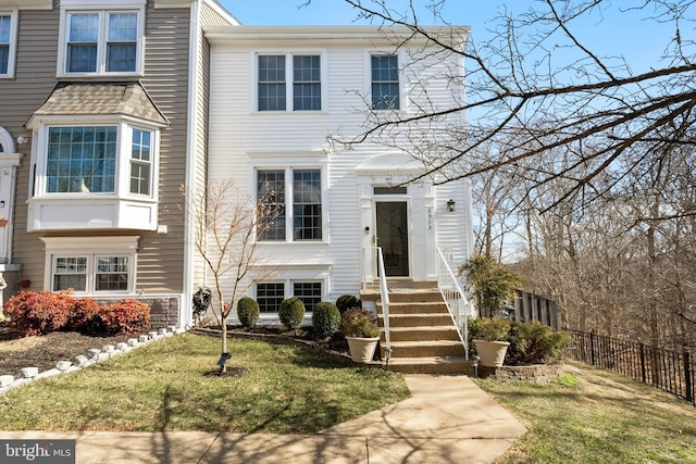 view of front of property with a front yard and fence