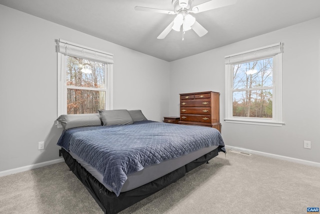 carpeted bedroom featuring baseboards and ceiling fan