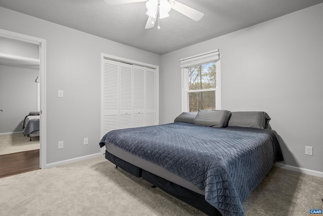 carpeted bedroom with a closet, ceiling fan, and baseboards