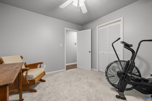 workout area with baseboards, carpet, and ceiling fan