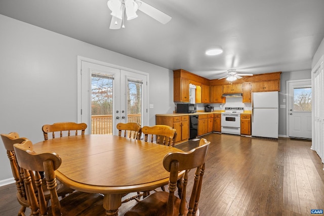 dining space featuring french doors, baseboards, a ceiling fan, and dark wood-style flooring