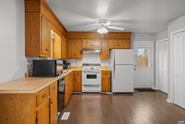 kitchen featuring white appliances, brown cabinetry, extractor fan, and light countertops