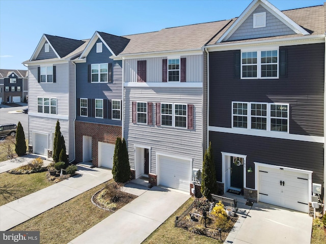 townhome / multi-family property featuring concrete driveway and an attached garage