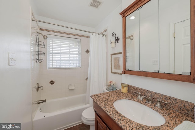 bathroom featuring toilet, shower / bath combo, vanity, and visible vents