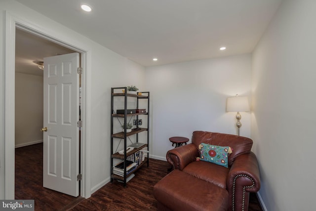 sitting room with baseboards, wood finished floors, and recessed lighting