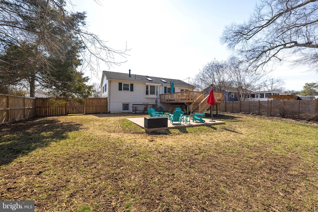 rear view of house with a yard, a patio area, a fenced backyard, and a wooden deck