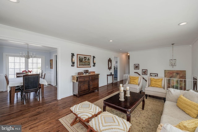 living area with a chandelier, ornamental molding, wood finished floors, and recessed lighting